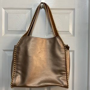 Bronze metallic hobo style purse with gold accents.
